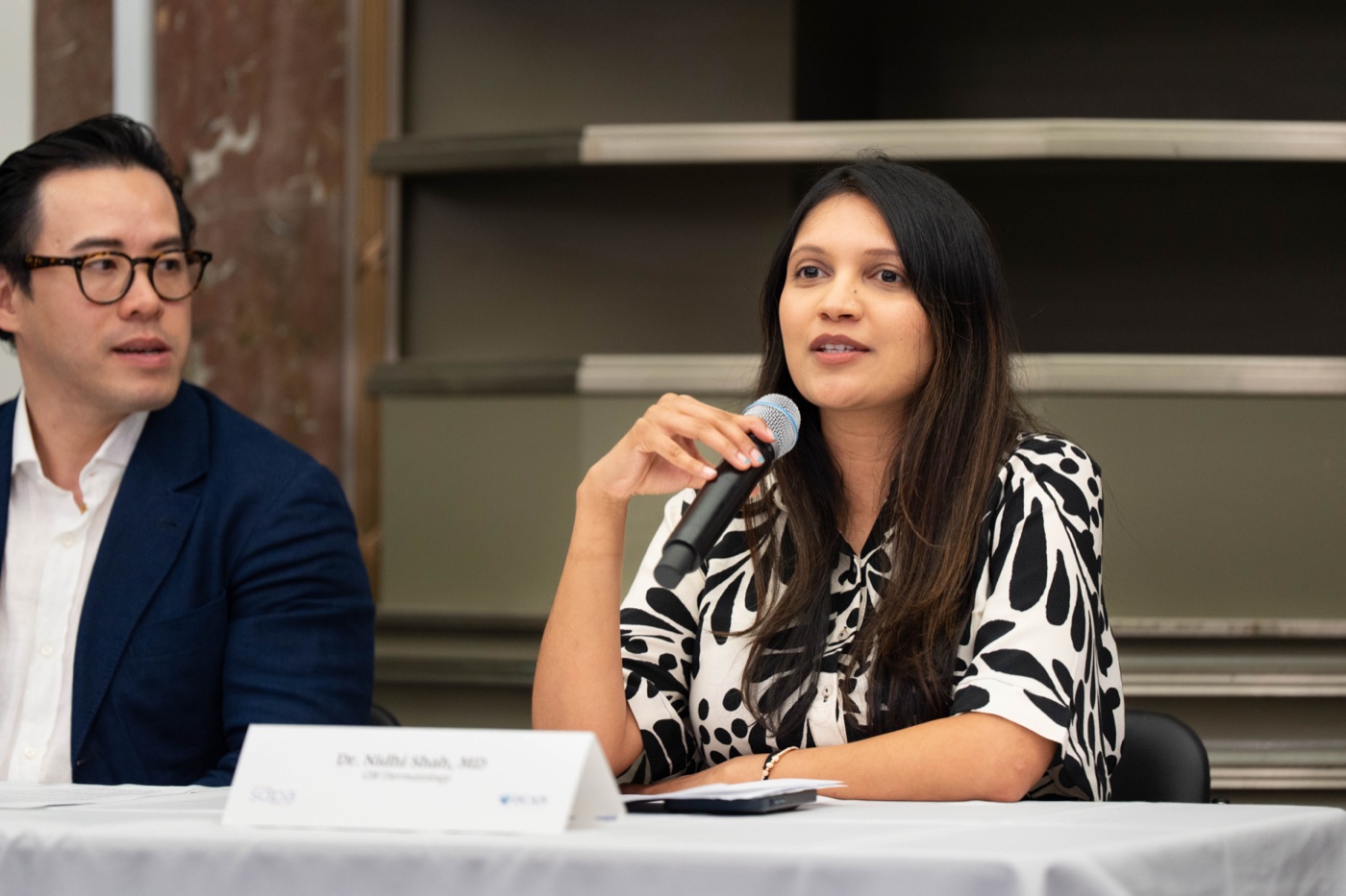 A panelist speaking into a microphone