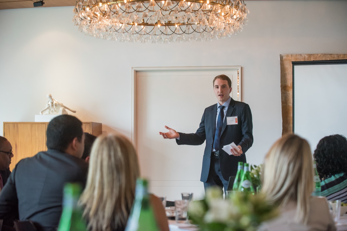 A speaker presenting to a seated group